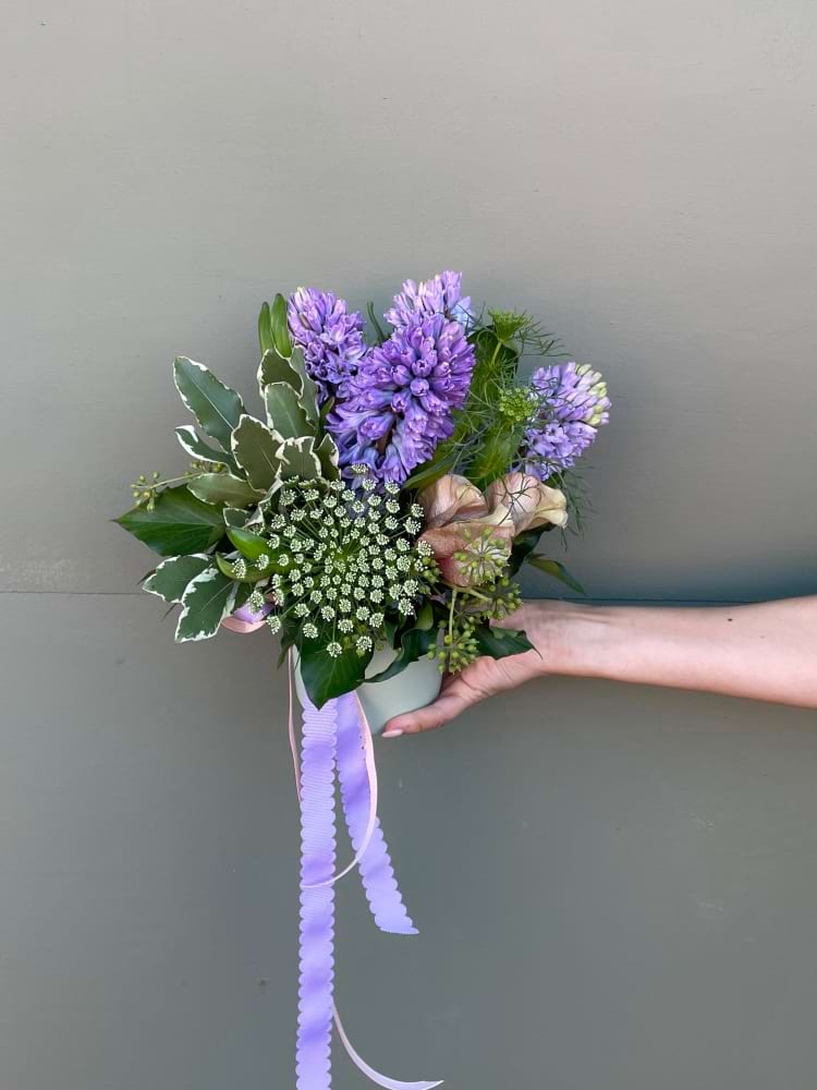 Small Vase arrangement of fragrant flowers and greenery ties with ribbon